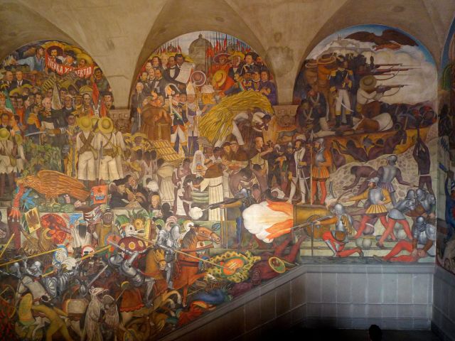 Colorful mural depicting Mexican history by Diego Rivera.